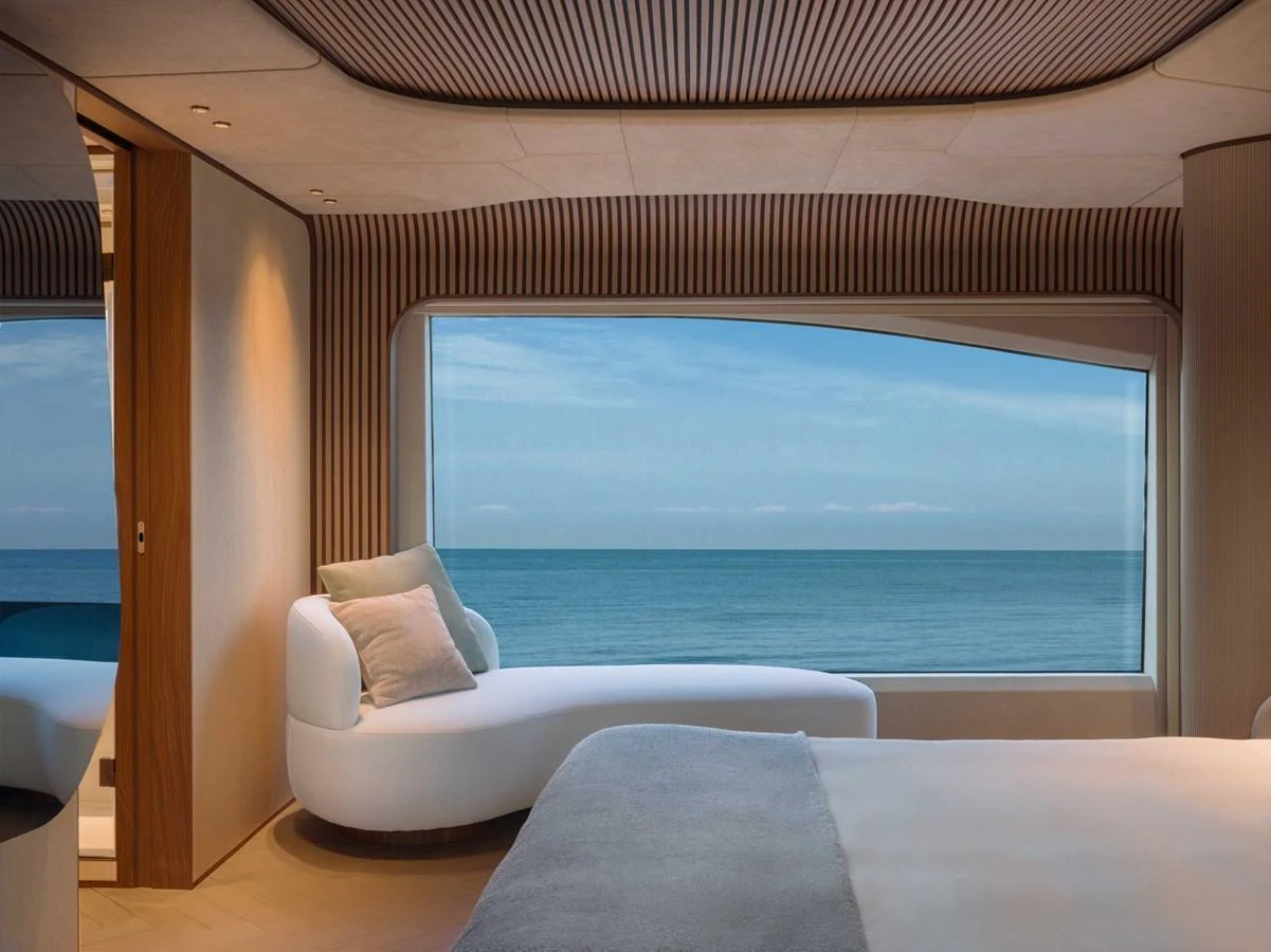 The stateroom offers a serene view of the ocean through a large window, complemented by elegant and modern furnishings. aboard PESA II Yacht for Sale