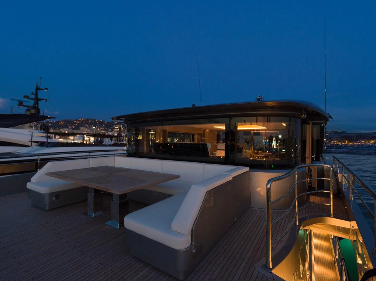 The yacht's aft deck features a spacious seating area with a table, perfect for evening relaxation. aboard PESA II Yacht for Sale