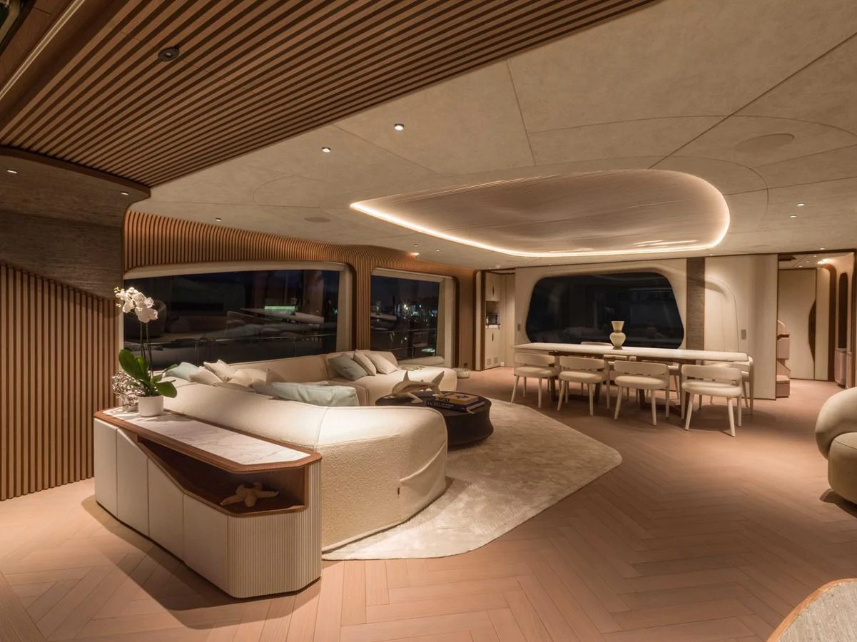The salon features elegant, modern furnishings with ample seating and ambient lighting. aboard PESA II Yacht for Sale