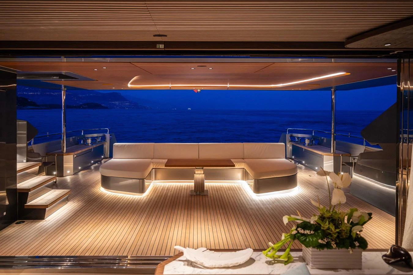 The aft deck offers a serene and luxurious space with ambient lighting and comfortable seating, perfect for evening relaxation. aboard PESA II Yacht for Sale
