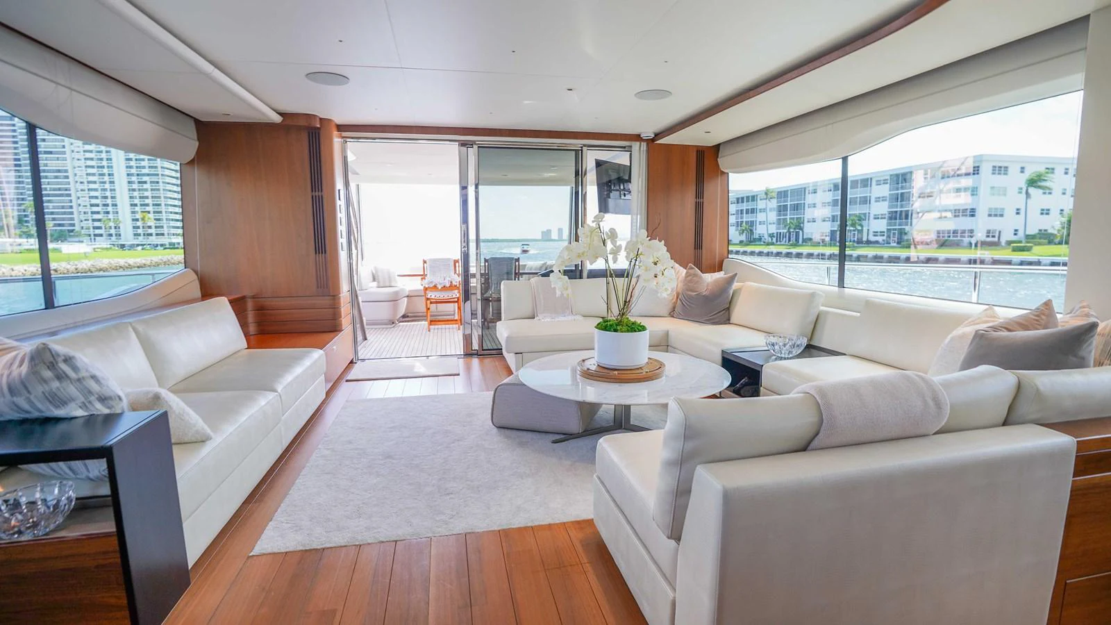 The spacious salon features luxurious seating with panoramic views of the water. aboard RECORD YEAR Yacht for Sale