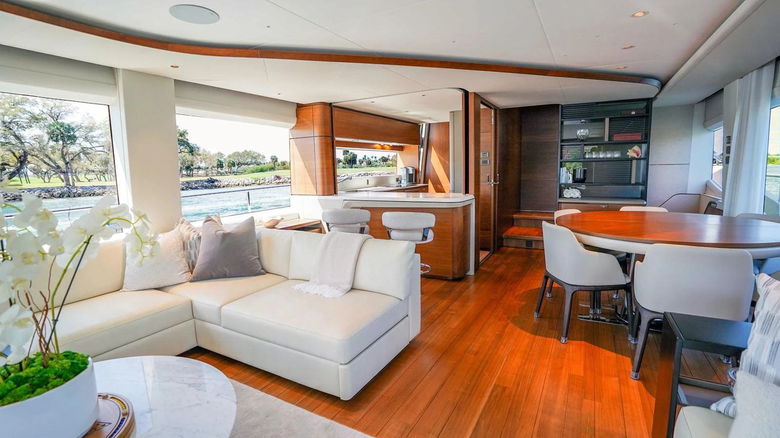 The yacht's salon features a spacious and elegant seating area with large windows offering scenic views. aboard RECORD YEAR Yacht for Sale