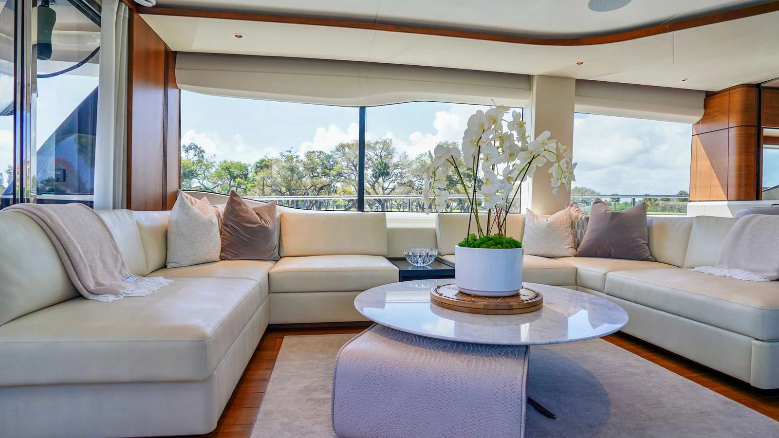 The yacht's salon features a spacious and elegant seating area with large windows offering scenic views. aboard RECORD YEAR Yacht for Sale
