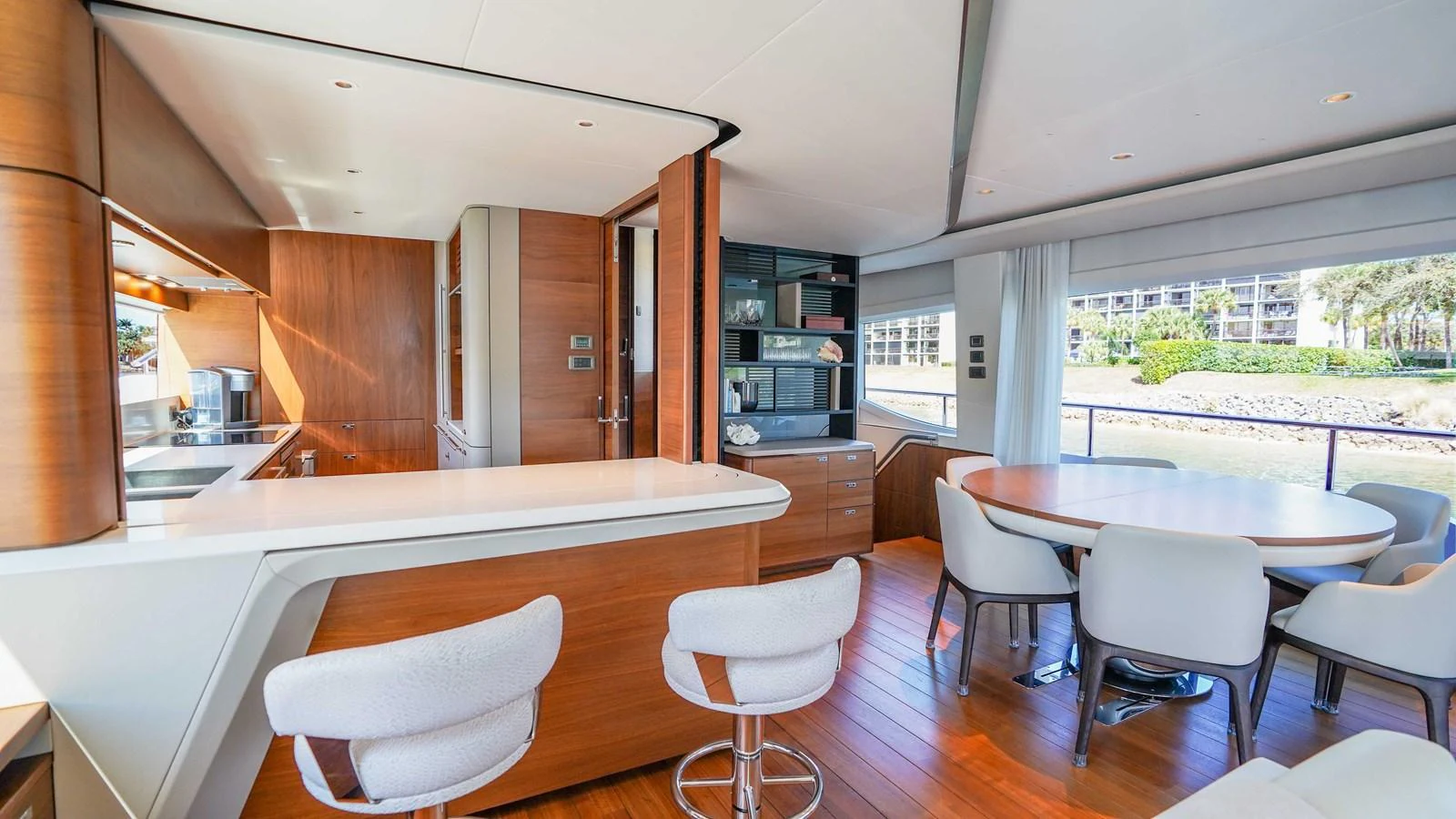 The yacht's salon features a modern dining area and a sleek galley with ample natural light. aboard RECORD YEAR Yacht for Sale