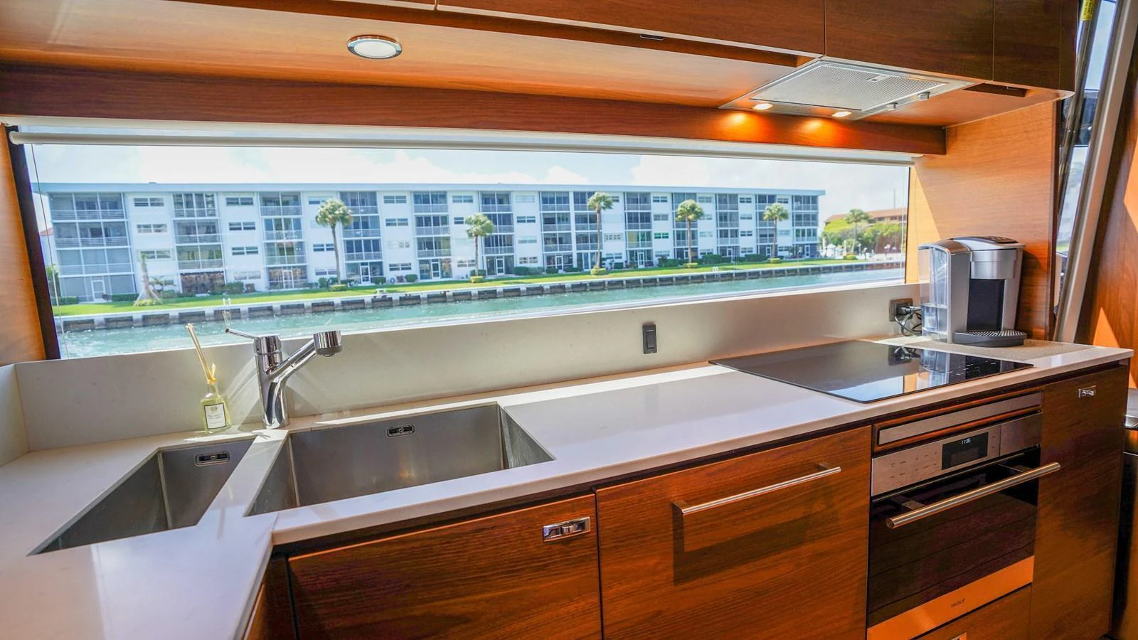 The yacht's galley features modern appliances and a large window with a scenic view. aboard RECORD YEAR Yacht for Sale