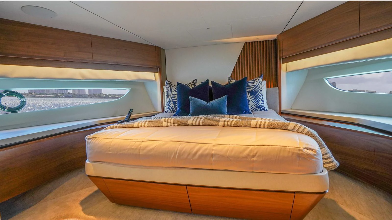 The master stateroom offers a luxurious and cozy retreat with elegant wood finishes and large windows. aboard RECORD YEAR Yacht for Sale