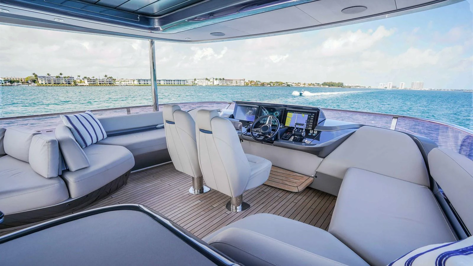 The helm area offers a spacious and comfortable seating arrangement with a panoramic view of the water. aboard RECORD YEAR Yacht for Sale