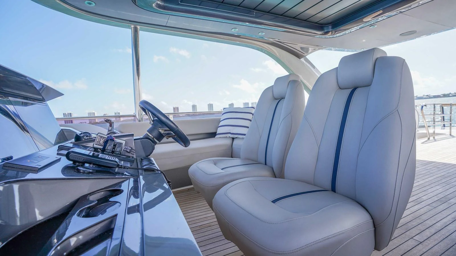 The helm area features luxurious seating with a sleek, modern design. aboard RECORD YEAR Yacht for Sale