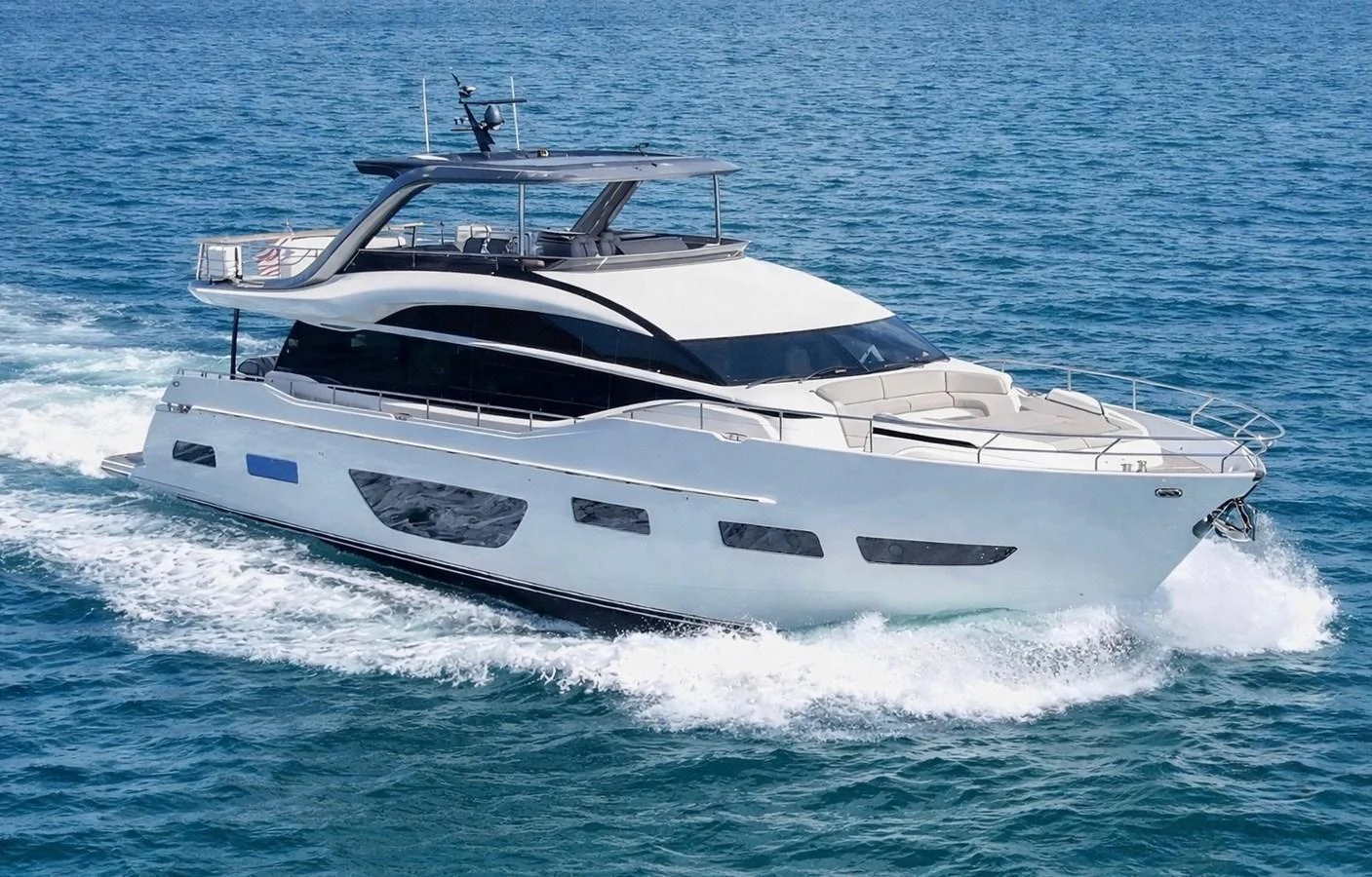 A sleek and modern yacht cruises through the open water, showcasing its elegant design and luxurious features. aboard RECORD YEAR Yacht for Sale