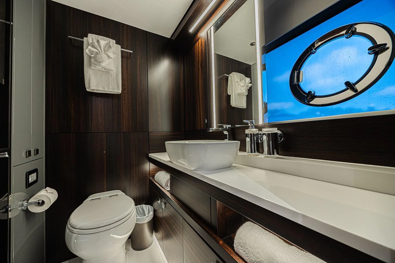 The yacht's bathroom features modern fixtures and a sleek design with dark wood accents. aboard HIDEOUT Yacht for Sale