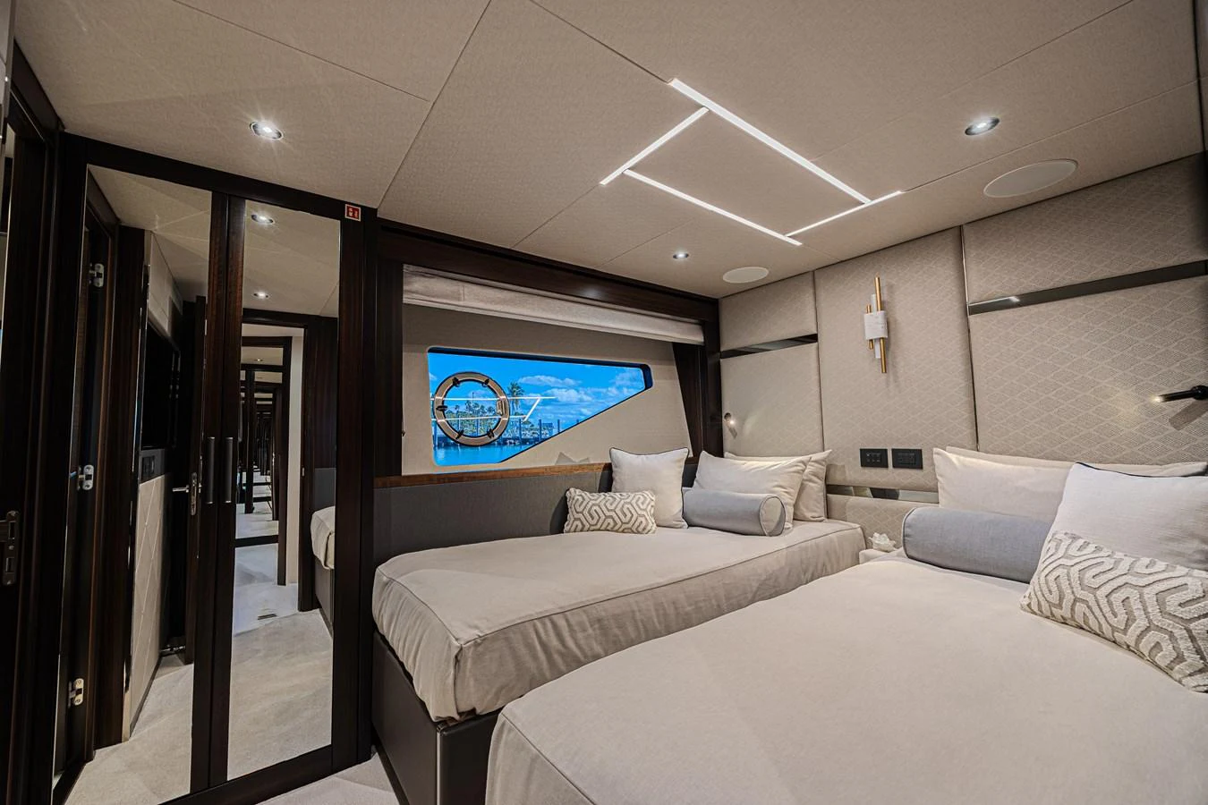 The guest stateroom features twin beds and a modern, elegant design with ample natural light. aboard HIDEOUT Yacht for Sale