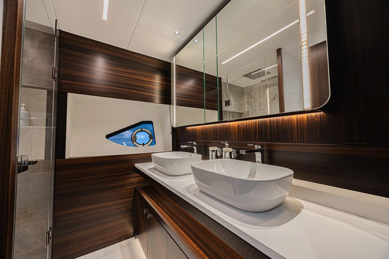 The yacht's bathroom features modern fixtures and elegant wood paneling. aboard HIDEOUT Yacht for Sale