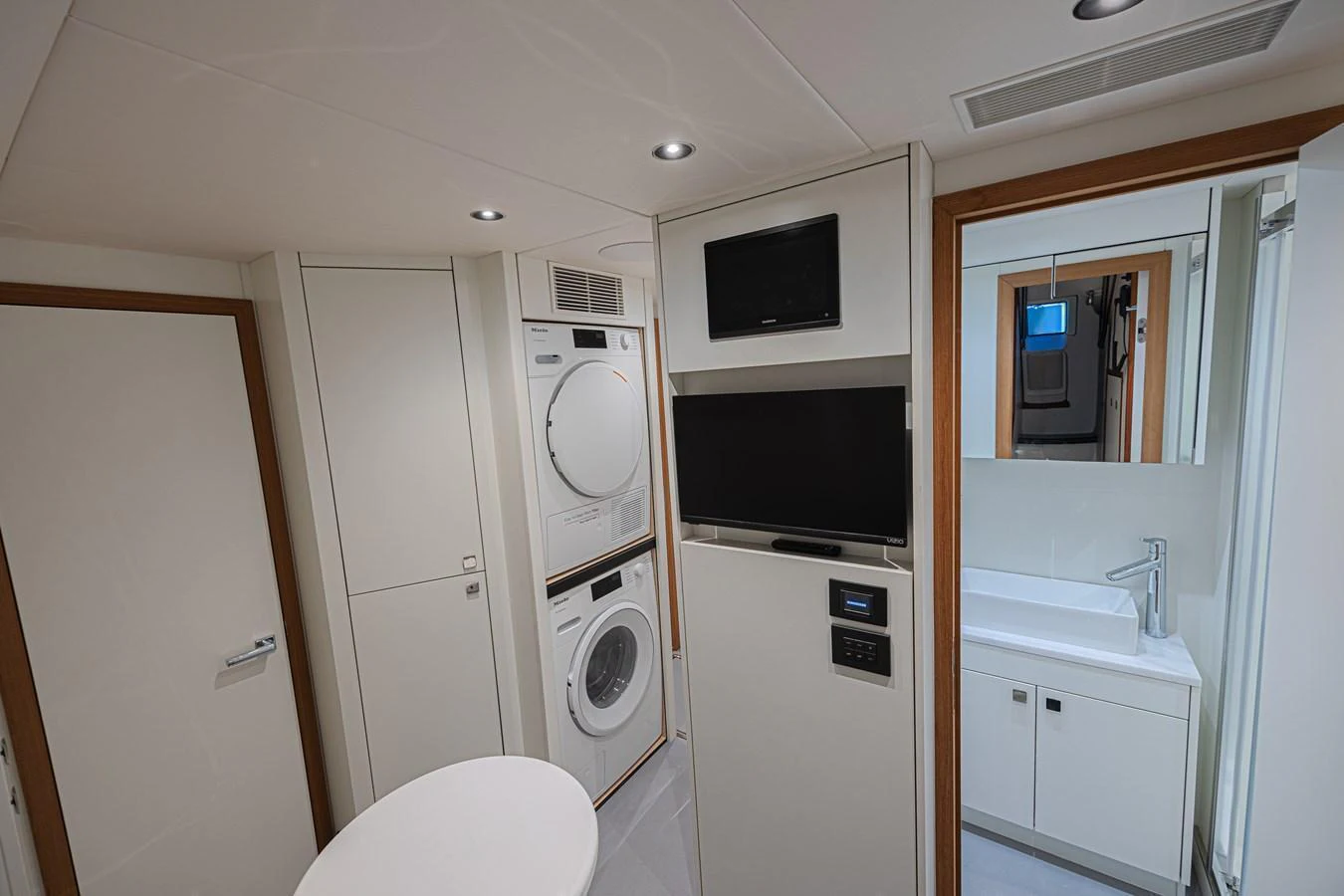 The yacht's laundry room is equipped with modern appliances and a sleek design. aboard HIDEOUT Yacht for Sale