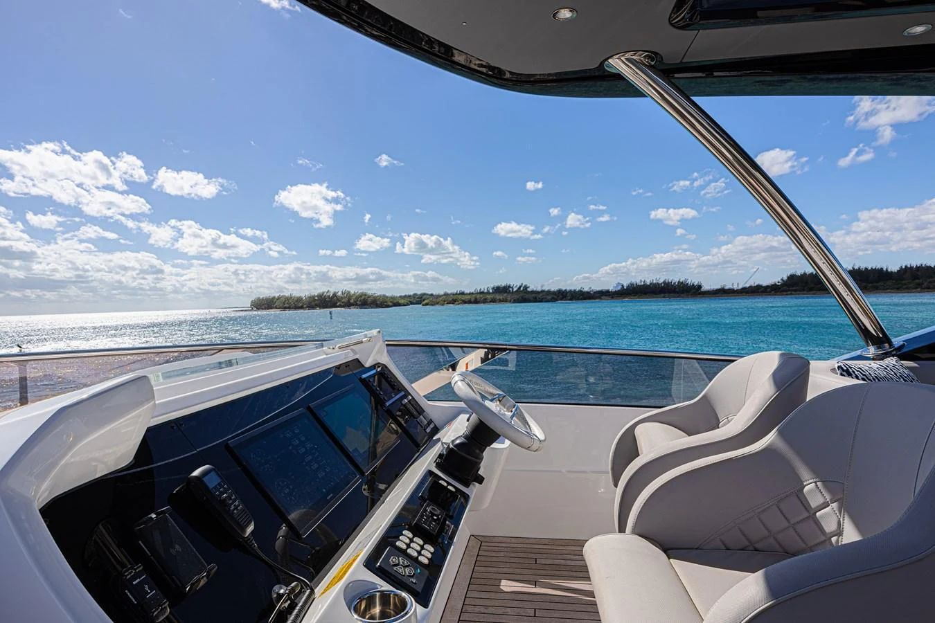 The helm station offers a commanding view of the serene waters and clear skies. aboard HIDEOUT Yacht for Sale