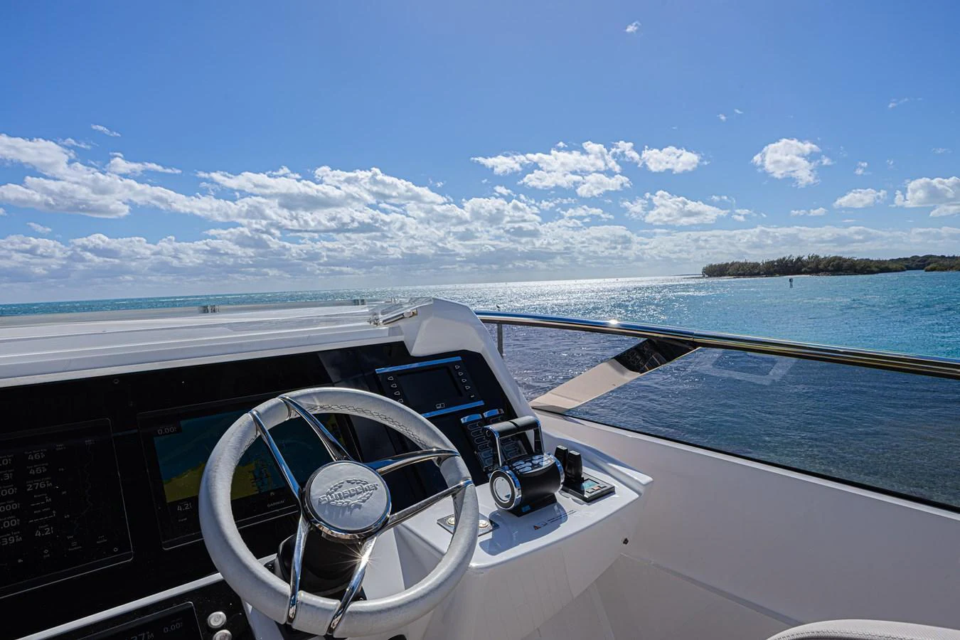 The helm station offers a commanding view of the open water, equipped with modern navigation instruments. aboard HIDEOUT Yacht for Sale
