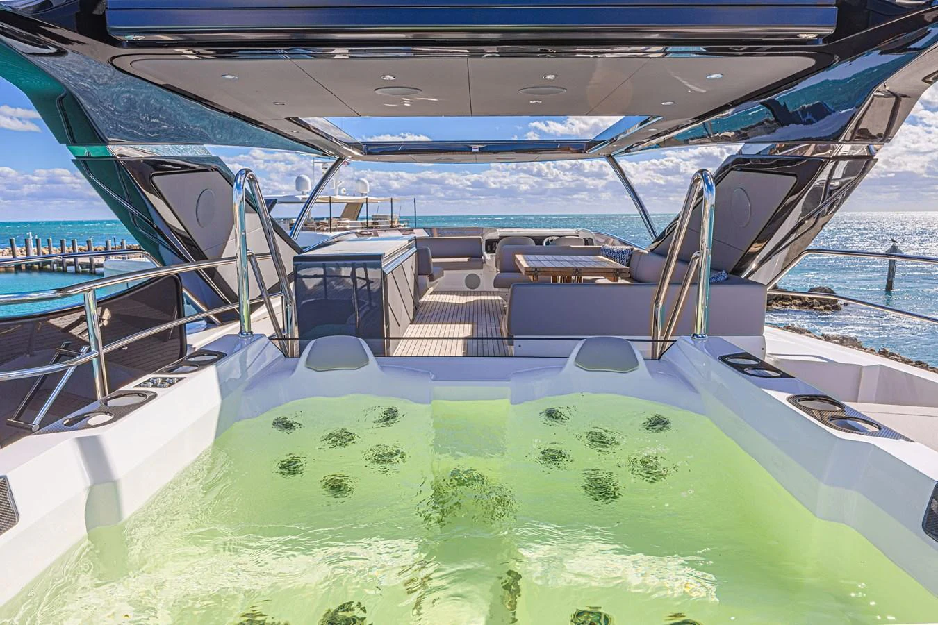 The sundeck features a luxurious hot tub with stunning ocean views. aboard HIDEOUT Yacht for Sale