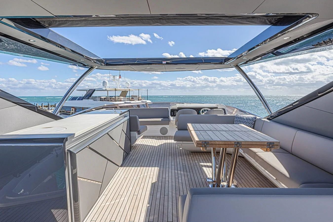 The flybridge offers a spacious and open area with ample seating and a dining table, perfect for enjoying the sea views. aboard HIDEOUT Yacht for Sale