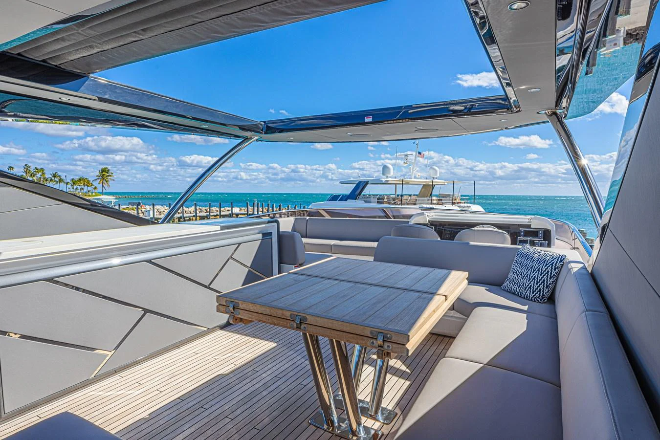 The flybridge offers a luxurious outdoor seating area with a stunning ocean view. aboard HIDEOUT Yacht for Sale