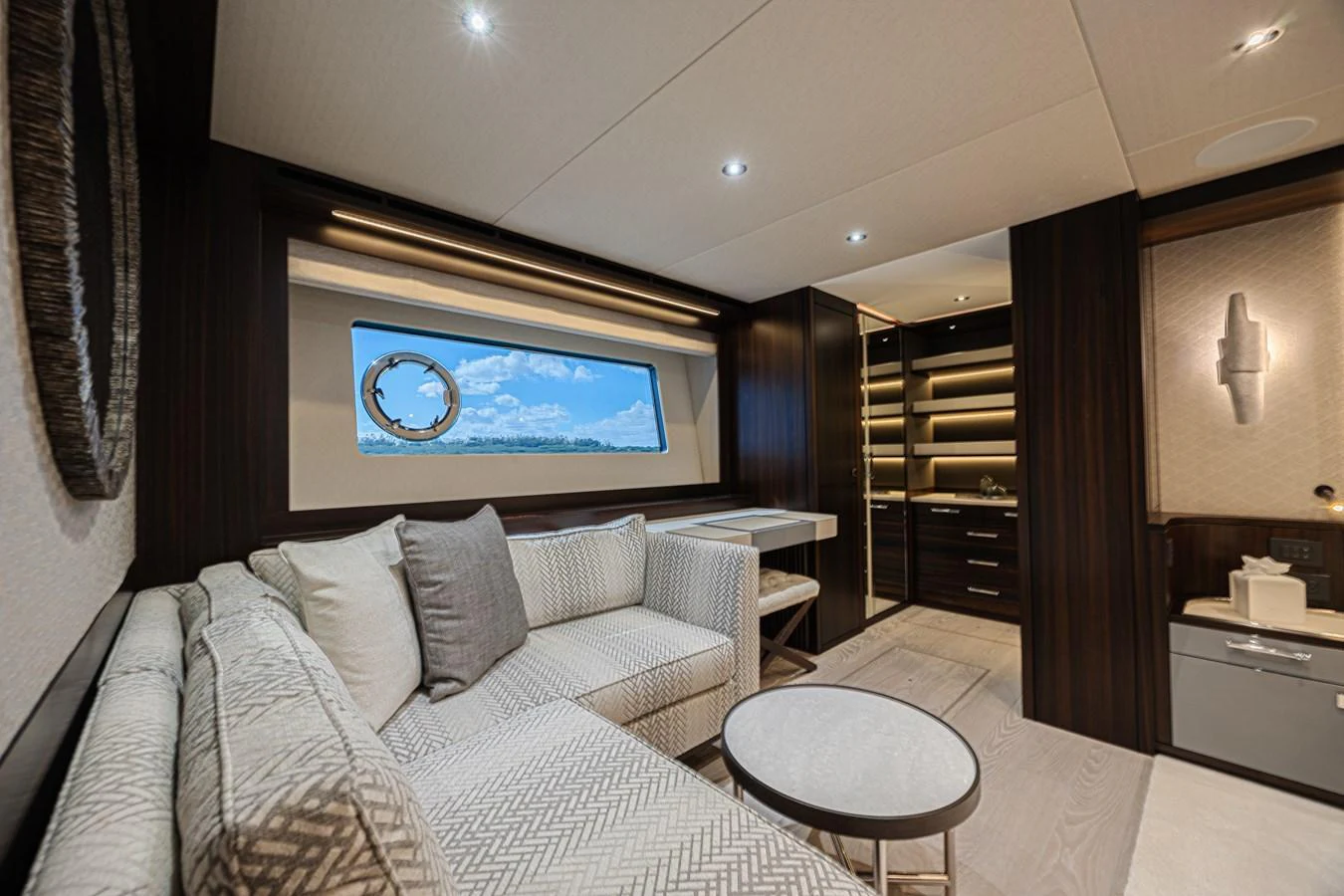 The salon features a comfortable seating area with a large window offering scenic views. aboard HIDEOUT Yacht for Sale
