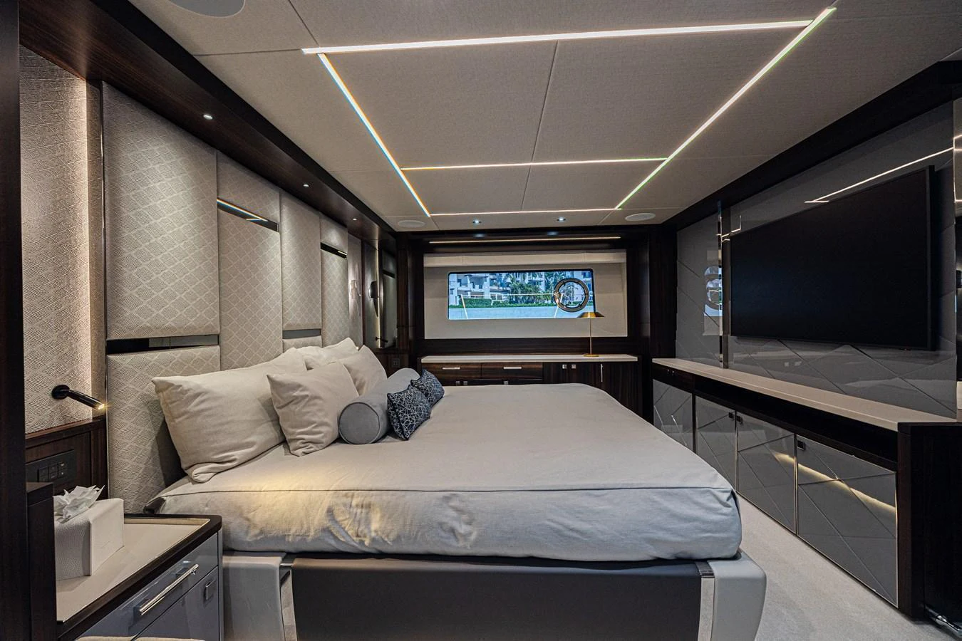 The master stateroom features a luxurious bed with elegant lighting and modern decor. aboard HIDEOUT Yacht for Sale