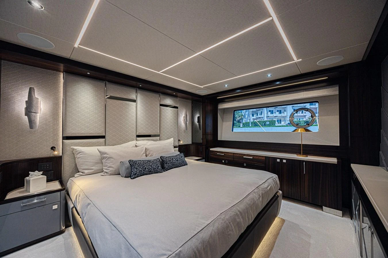 The master stateroom features a luxurious bed with modern lighting and elegant decor. aboard HIDEOUT Yacht for Sale