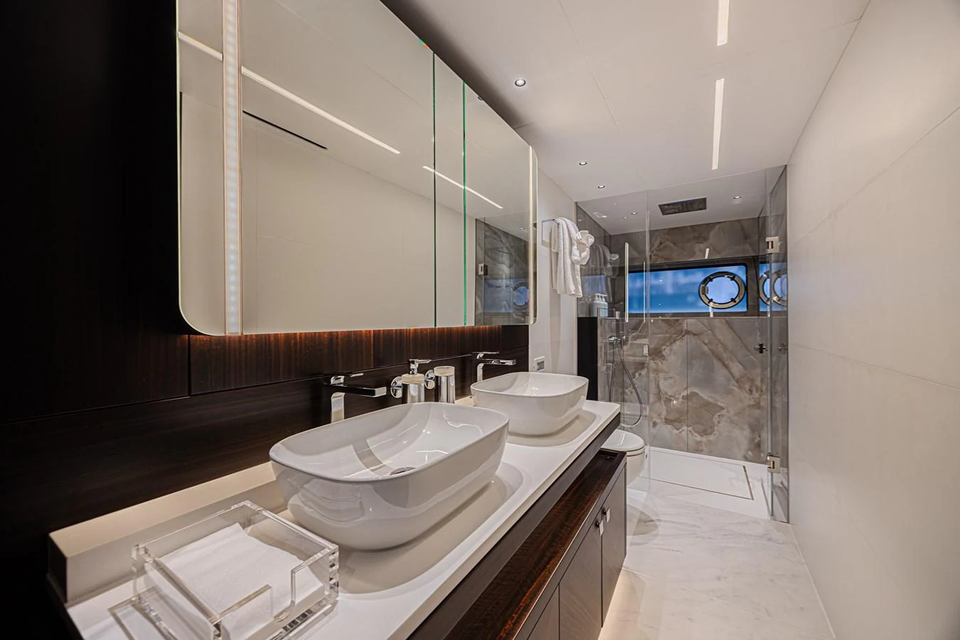 The yacht's bathroom features modern fixtures and a luxurious shower area. aboard HIDEOUT Yacht for Sale