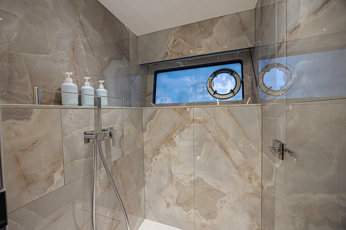 The yacht's bathroom features elegant marble walls and modern fixtures, creating a luxurious and serene atmosphere. aboard HIDEOUT Yacht for Sale