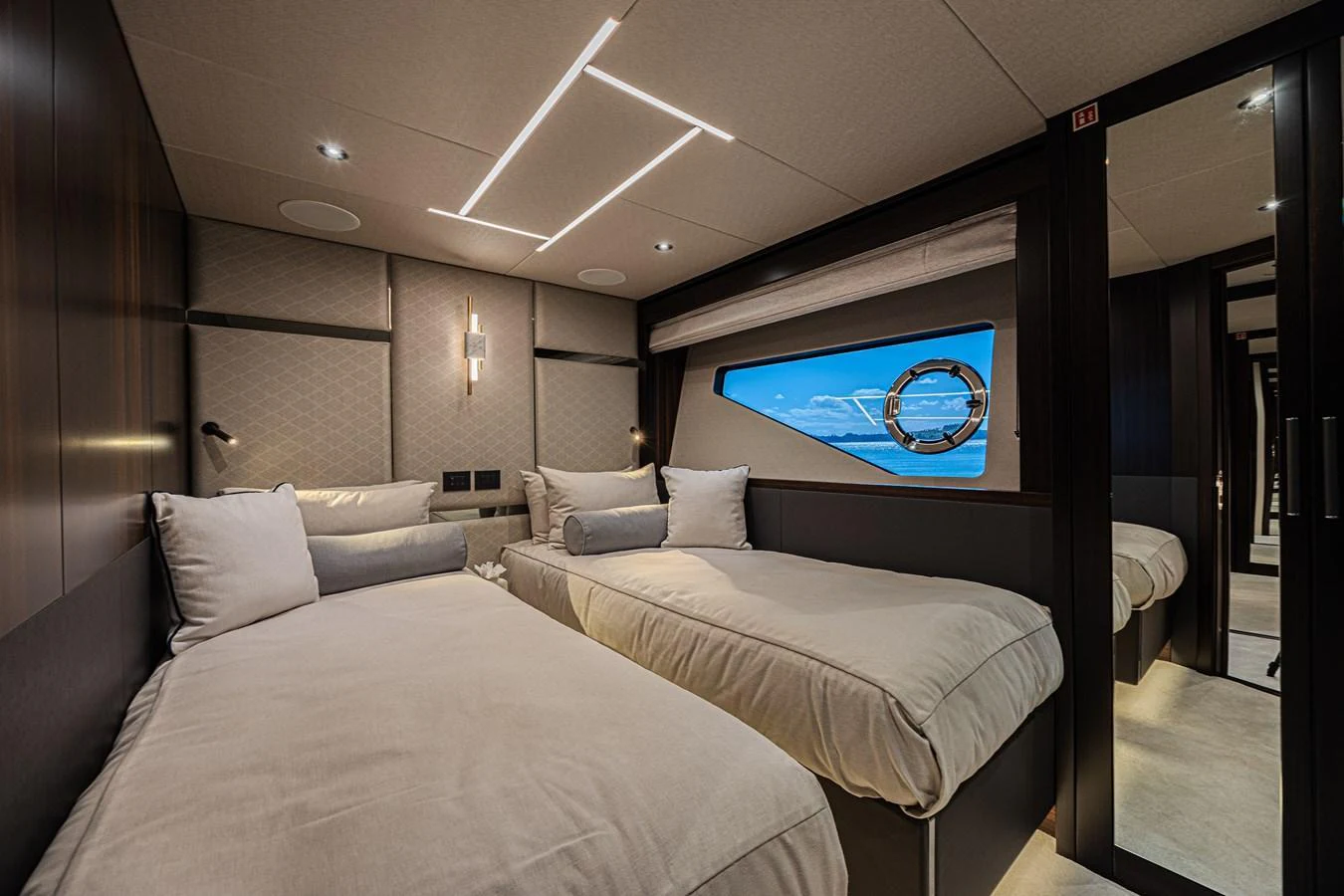 The guest stateroom features twin beds with a modern and cozy design. aboard HIDEOUT Yacht for Sale