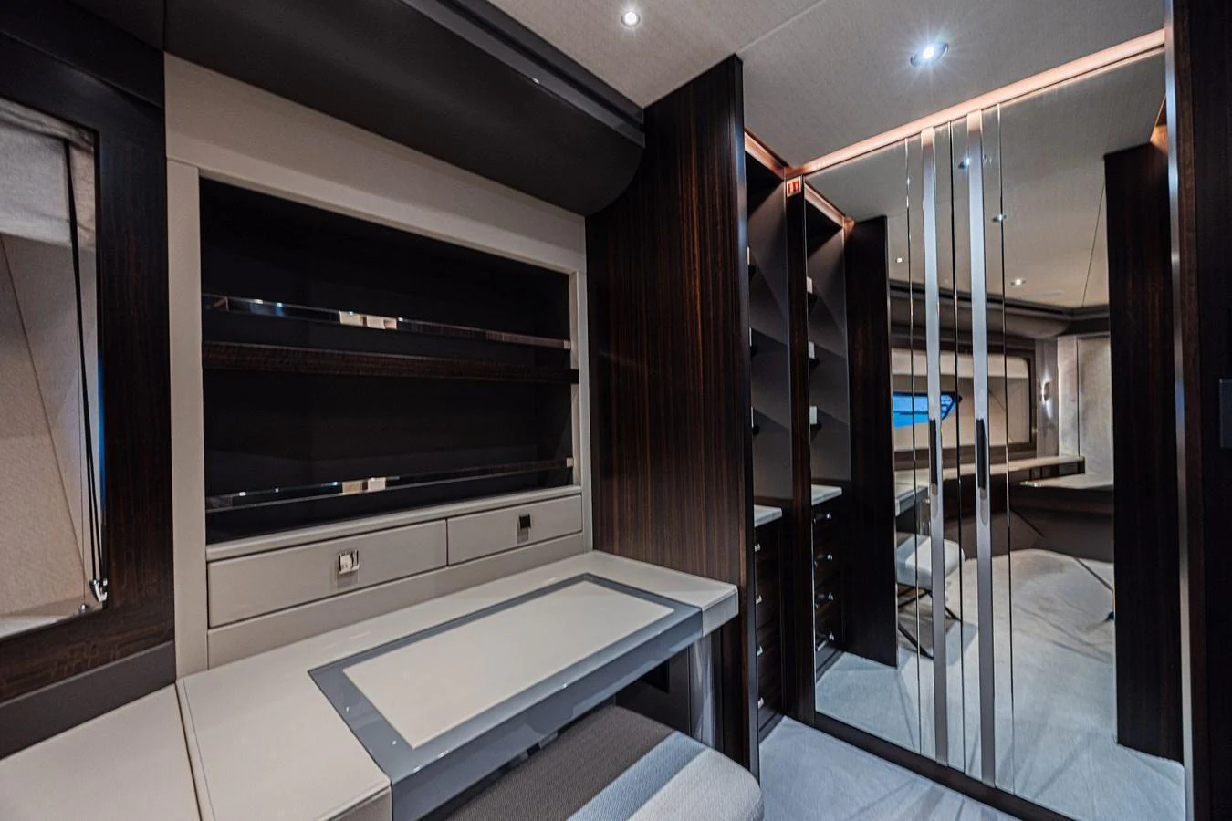 The yacht's interior features a modern and sleek design with dark wood accents and ample storage space. aboard HIDEOUT Yacht for Sale