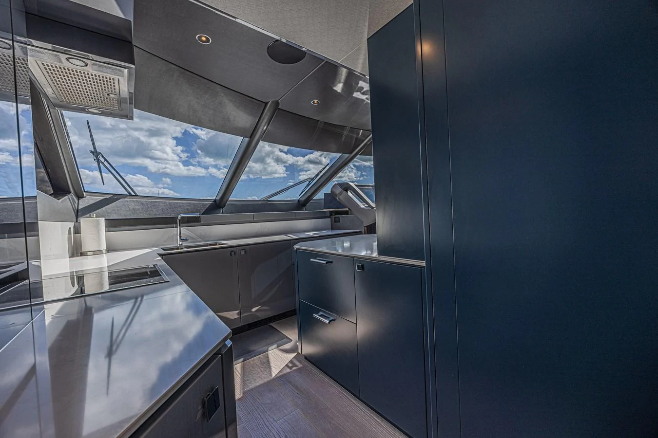 The sleek and modern galley features high-end appliances and ample counter space with a stunning view through large windows. aboard HIDEOUT Yacht for Sale