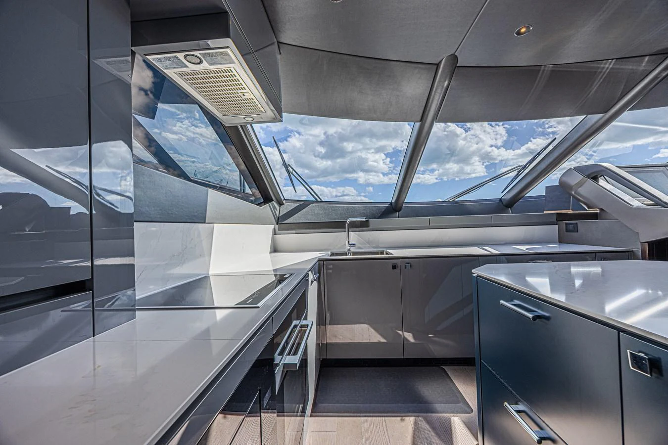 The sleek and modern galley features high-end appliances and expansive windows offering stunning views. aboard HIDEOUT Yacht for Sale