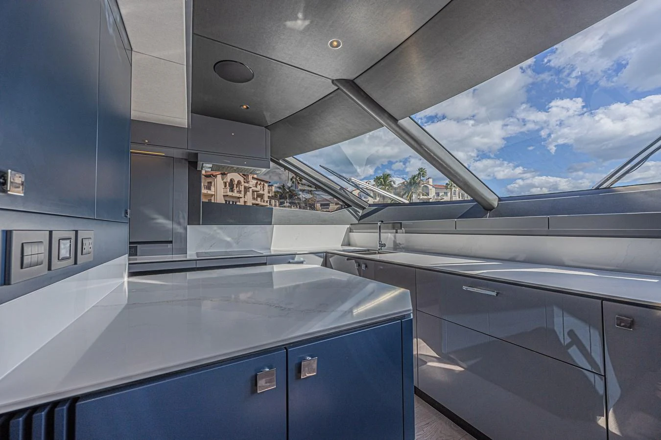 The sleek and modern galley features expansive windows and high-end finishes. aboard HIDEOUT Yacht for Sale