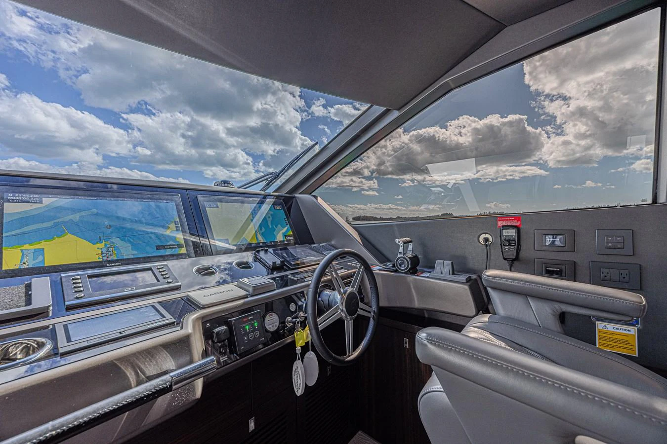 The helm station offers a commanding view with state-of-the-art navigation equipment and luxurious seating. aboard HIDEOUT Yacht for Sale