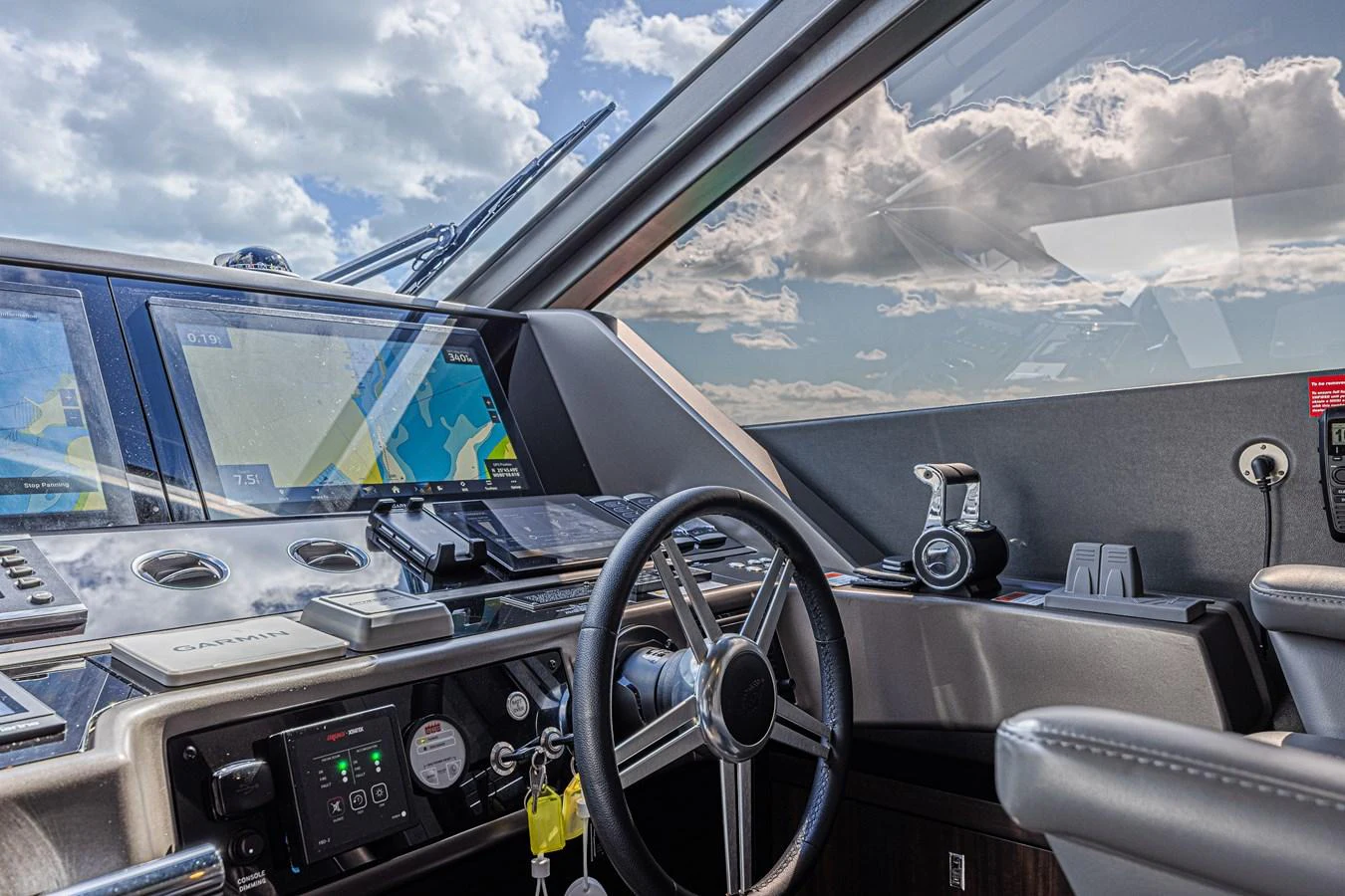 The helm station features advanced navigation equipment and a sleek, modern design. aboard HIDEOUT Yacht for Sale