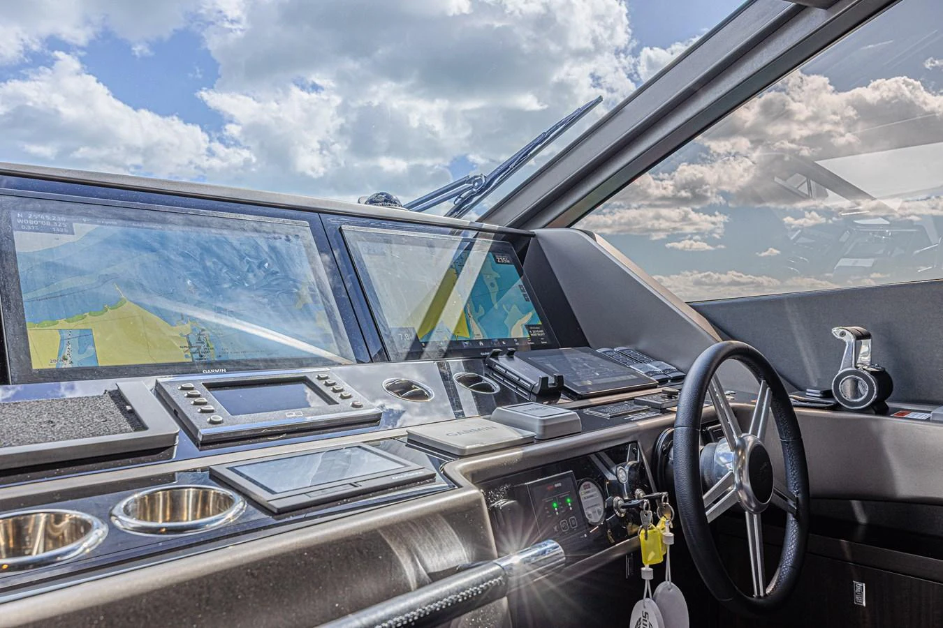 The helm station features advanced navigation equipment and a sleek, modern design. aboard HIDEOUT Yacht for Sale