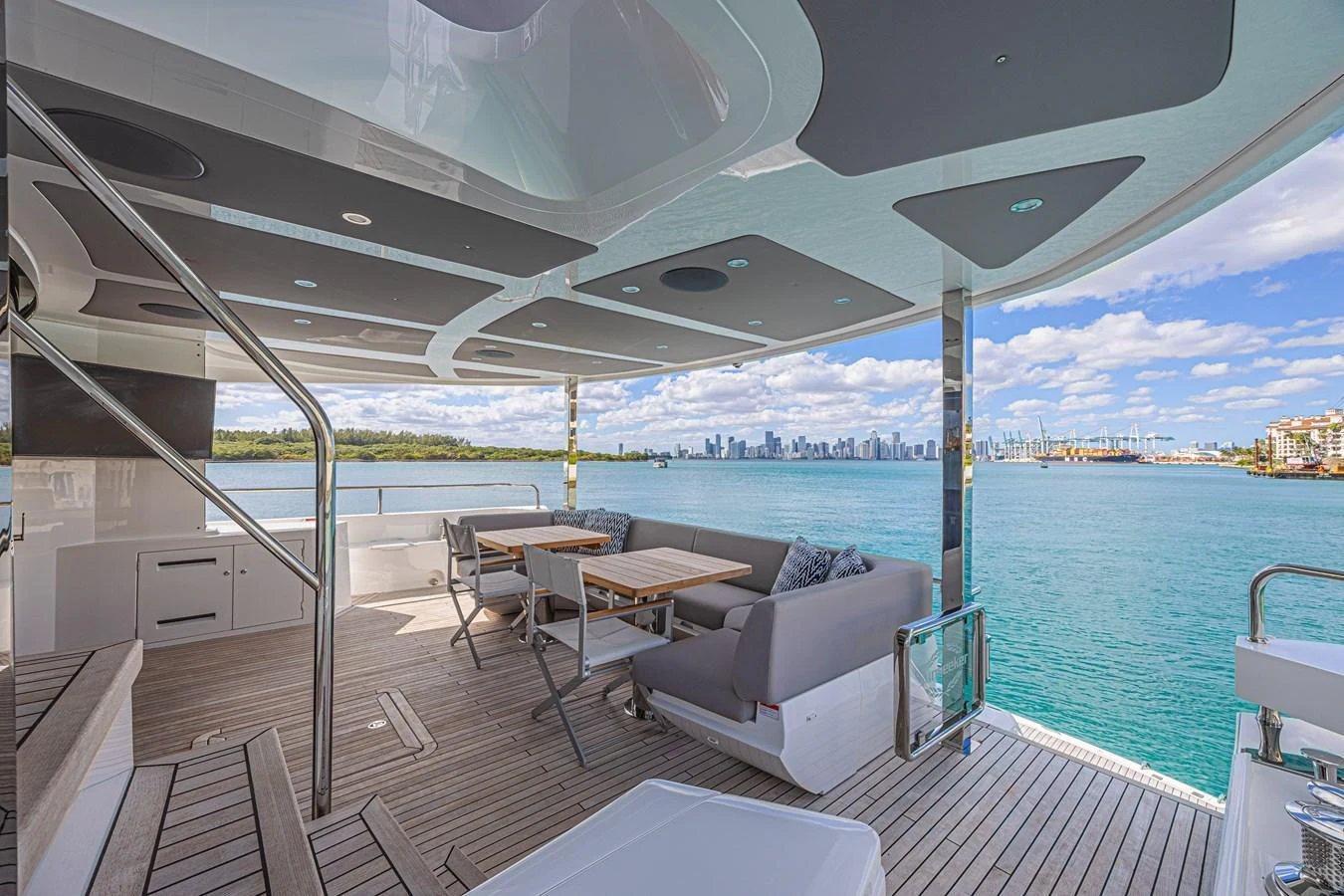 The aft deck offers a spacious and comfortable seating area with stunning views of the water and city skyline. aboard HIDEOUT Yacht for Sale