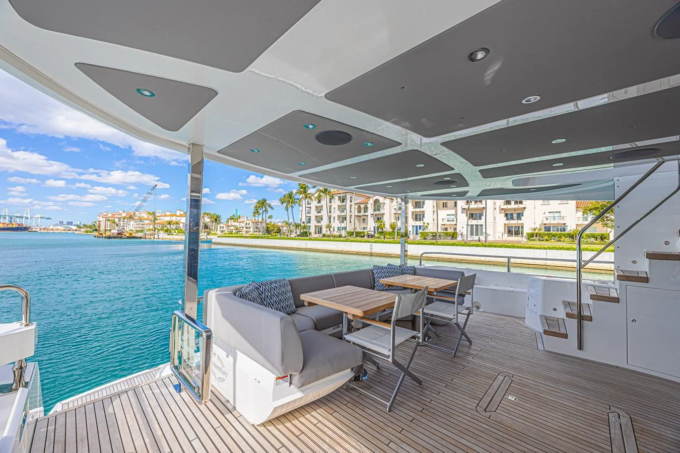 The aft deck offers a spacious and comfortable seating area with a stunning waterfront view. aboard HIDEOUT Yacht for Sale