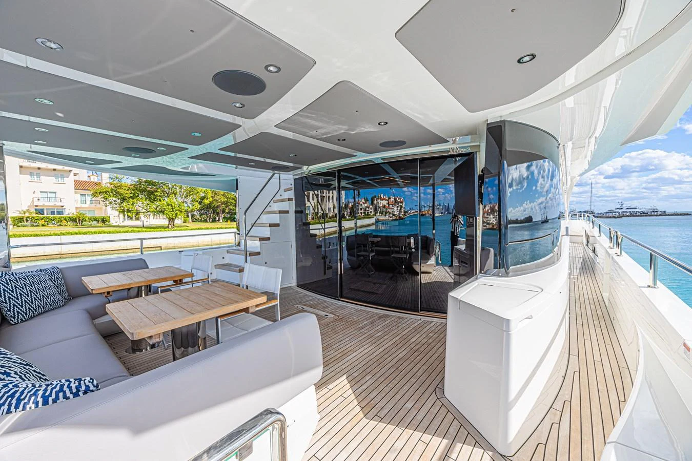 The aft deck features comfortable seating and a dining area with a view of the water. aboard HIDEOUT Yacht for Sale