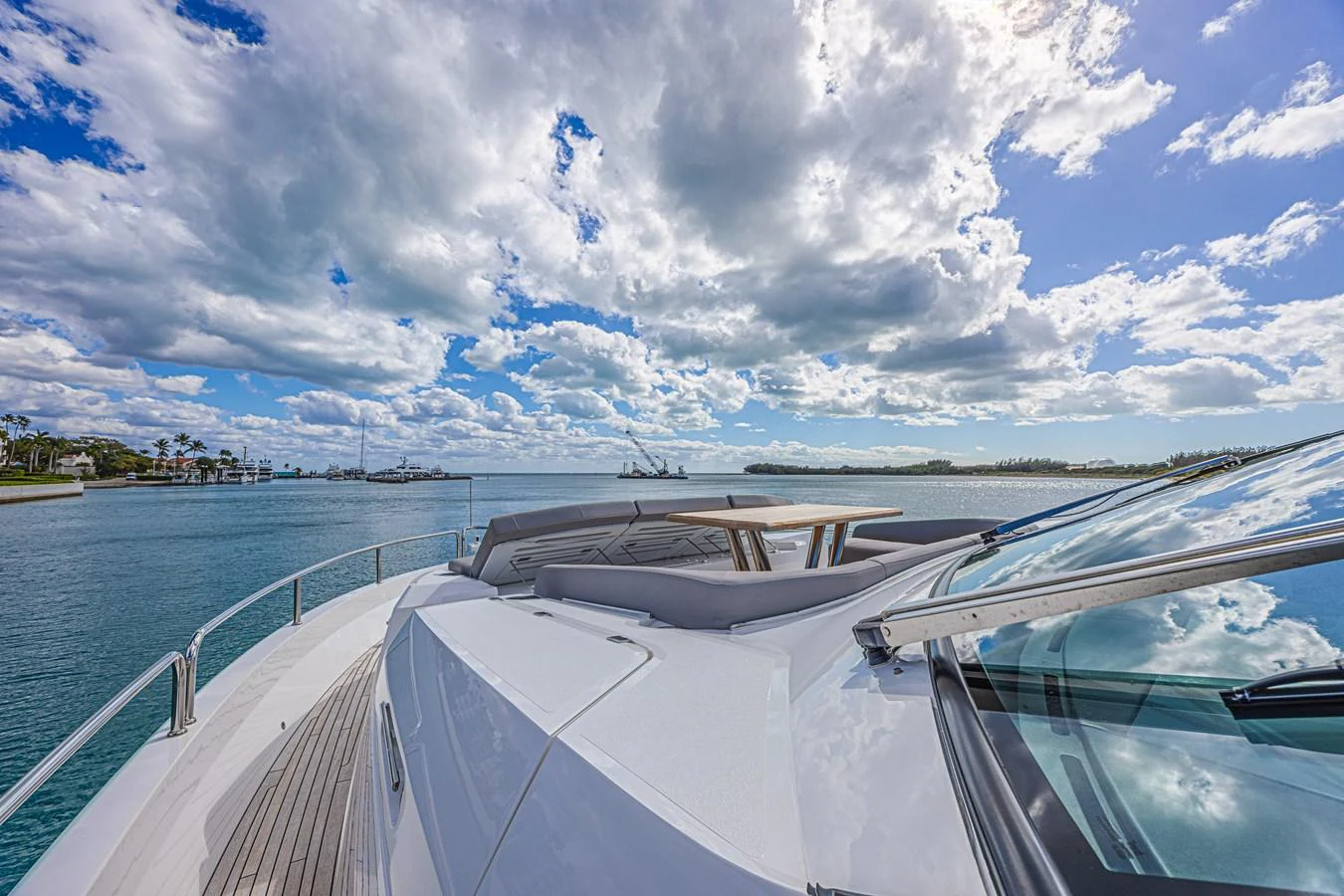 The yacht's bow offers a stunning view of the open water under a partly cloudy sky. aboard HIDEOUT Yacht for Sale
