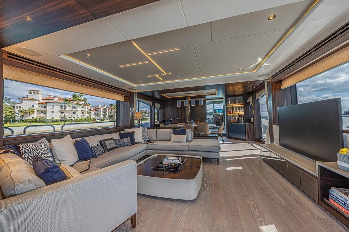 The spacious salon features luxurious seating, modern decor, and expansive windows offering stunning views. aboard HIDEOUT Yacht for Sale