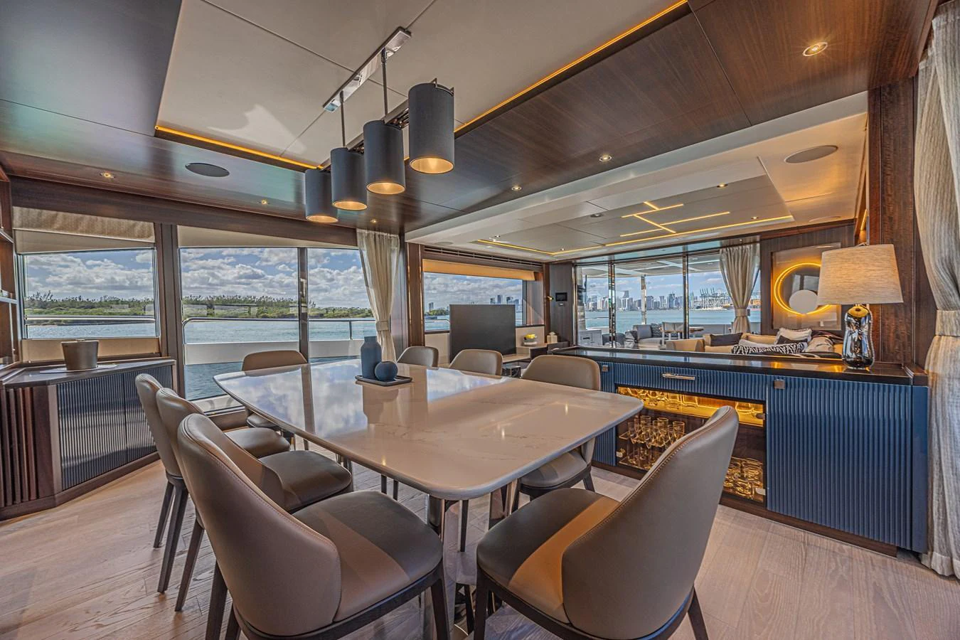 The yacht's dining area features a modern and elegant design with panoramic views of the surrounding waters. aboard HIDEOUT Yacht for Sale