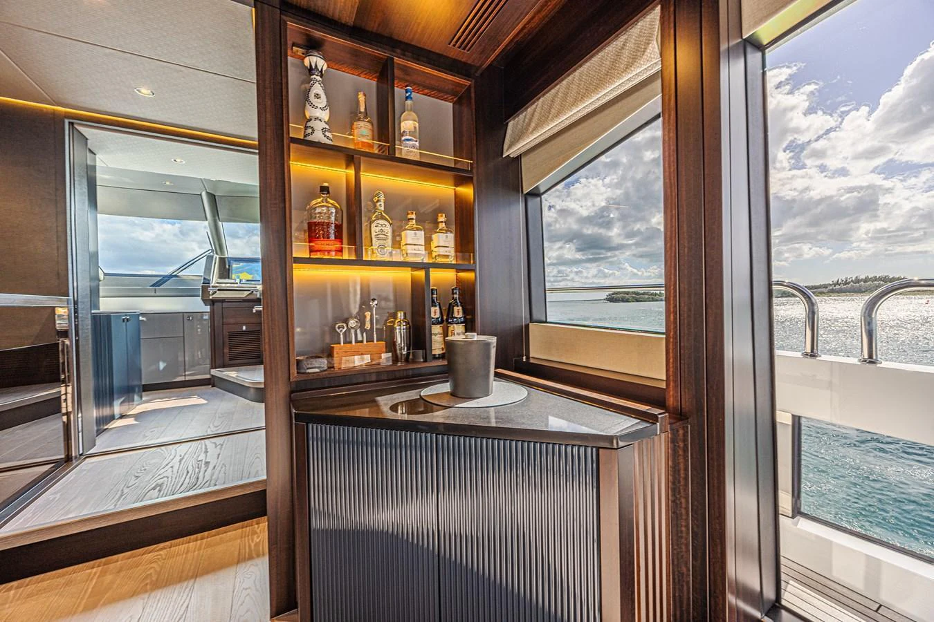The yacht's interior features a sophisticated bar area with a view of the sea. aboard HIDEOUT Yacht for Sale