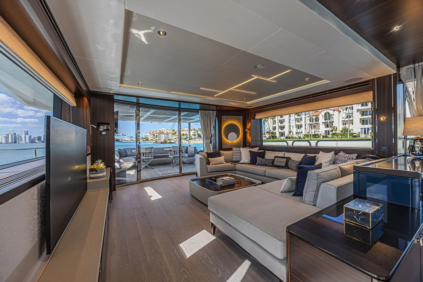 The salon offers a spacious and luxurious seating area with panoramic views of the water and cityscape. aboard HIDEOUT Yacht for Sale