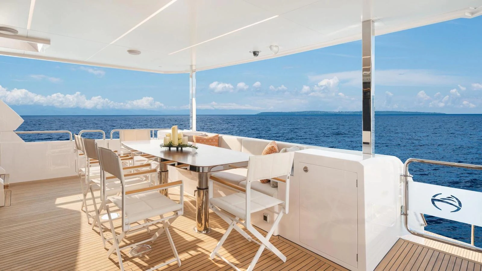 The aft deck features a spacious dining area with stunning ocean views. aboard HAPPY HEART Yacht for Sale