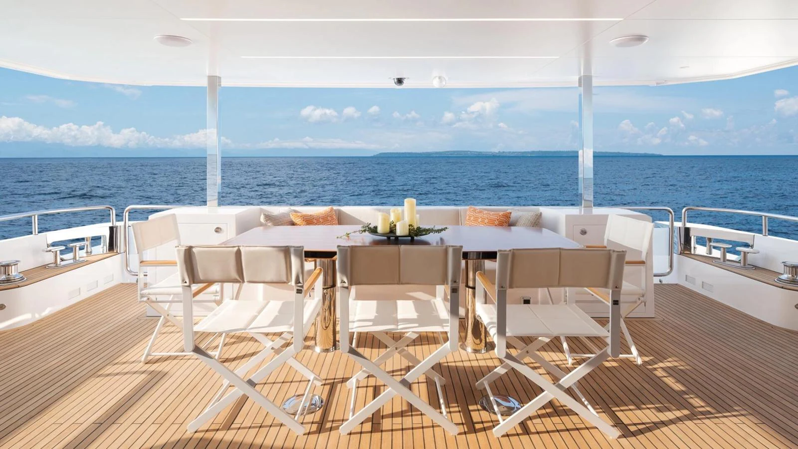 The aft deck features a spacious dining area with stunning ocean views. aboard HAPPY HEART Yacht for Sale