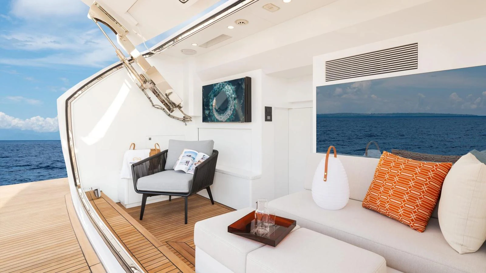 The aft deck offers a comfortable seating area with a stunning view of the ocean. aboard HAPPY HEART Yacht for Sale