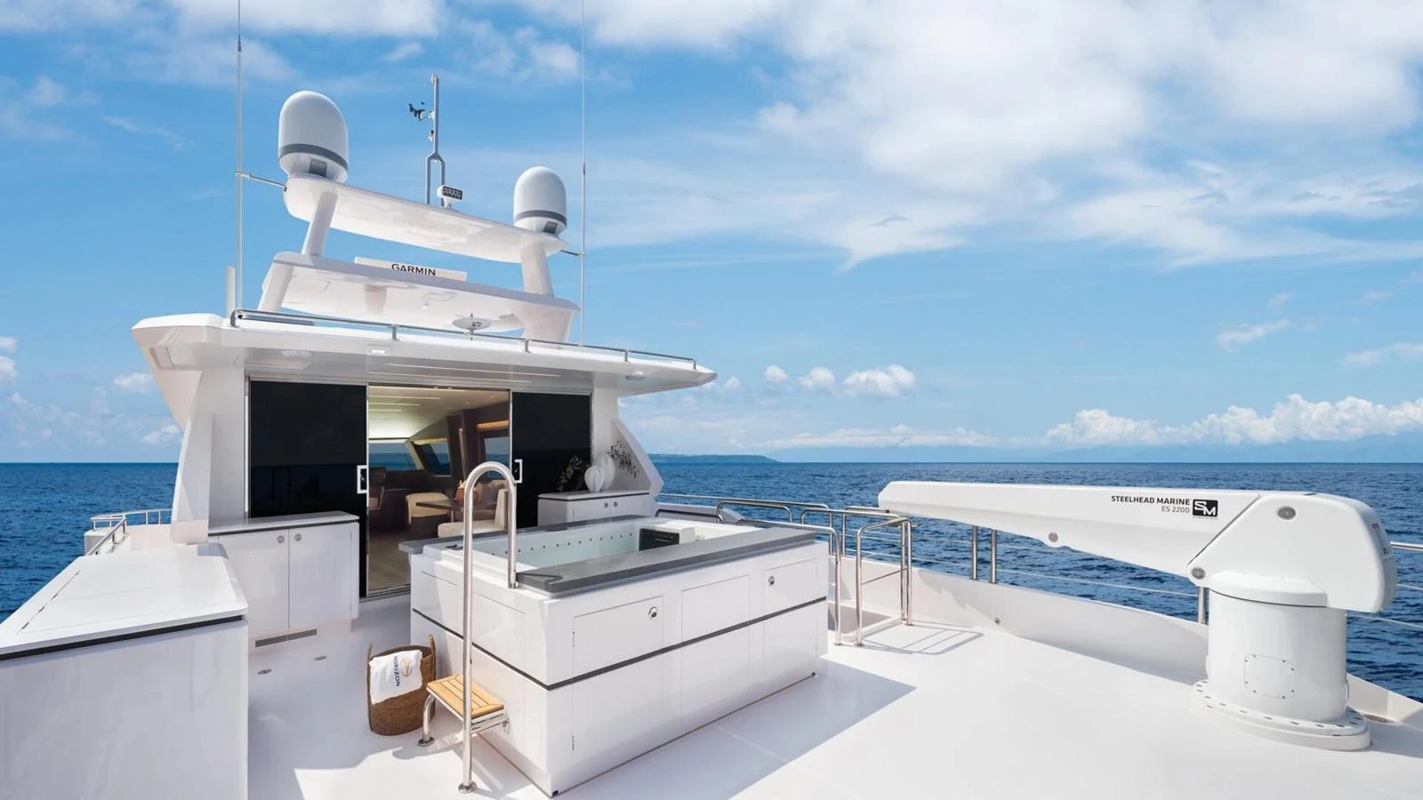 The sundeck features a luxurious hot tub and ample lounging space with stunning ocean views. aboard HAPPY HEART Yacht for Sale