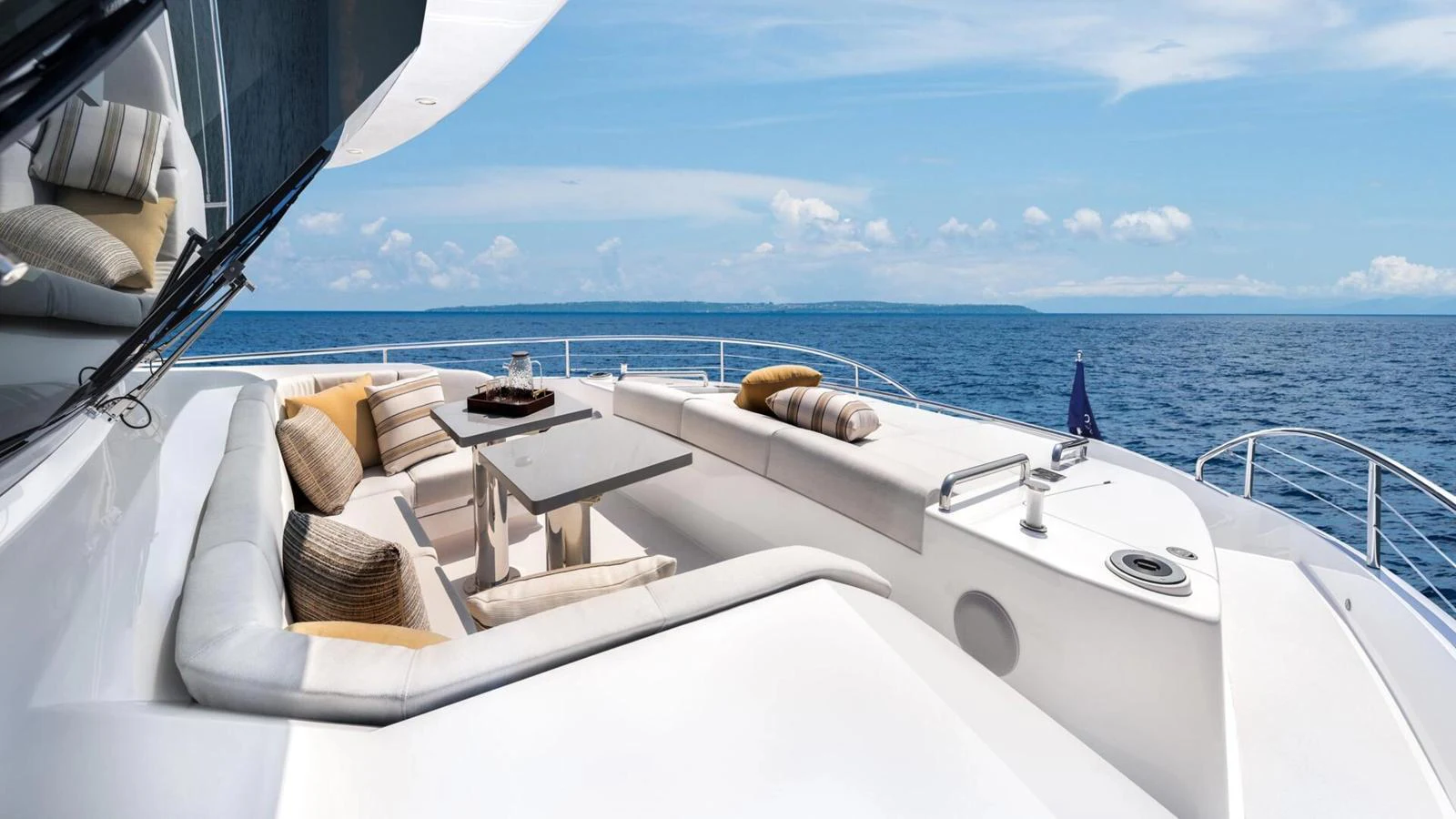 The flybridge offers a luxurious seating area with stunning ocean views. aboard HAPPY HEART Yacht for Sale