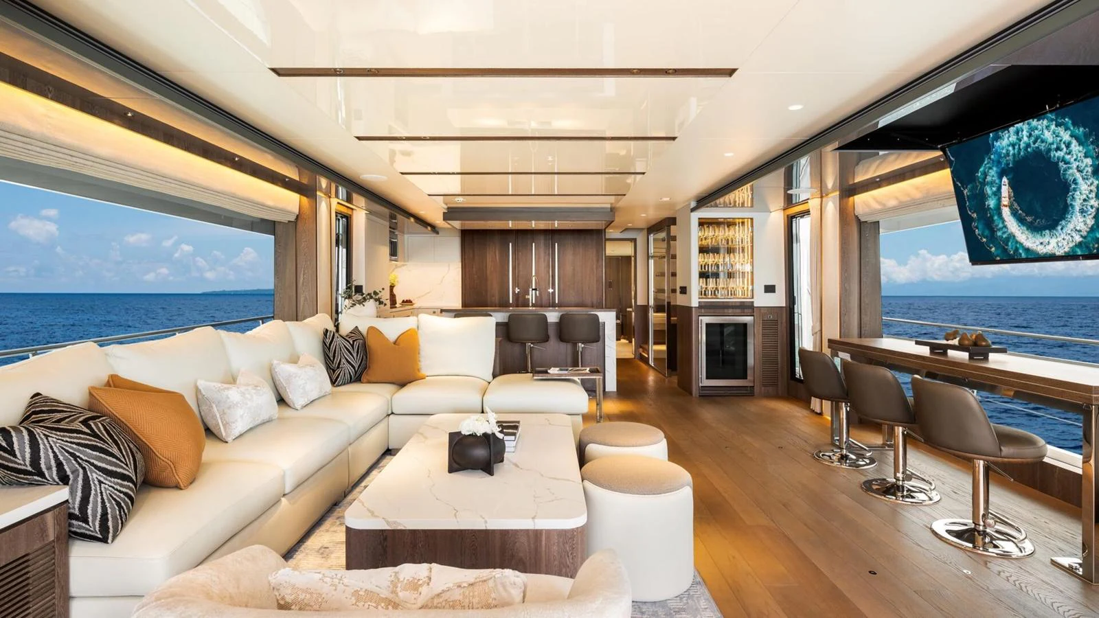 The spacious salon features luxurious seating, a modern entertainment system, and stunning ocean views. aboard HAPPY HEART Yacht for Sale