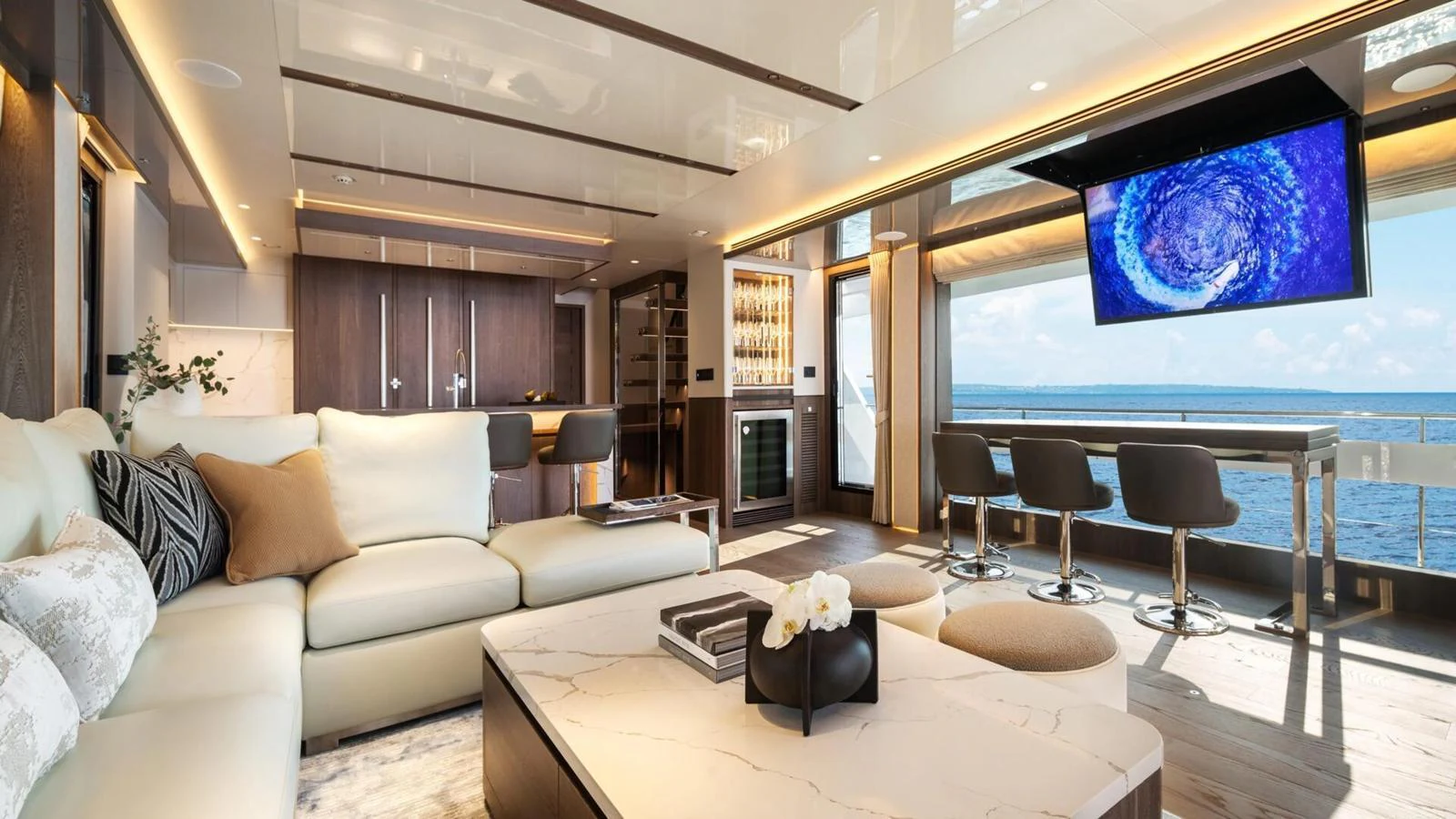 The yacht's salon offers a luxurious and spacious living area with modern furnishings and a stunning ocean view. aboard HAPPY HEART Yacht for Sale